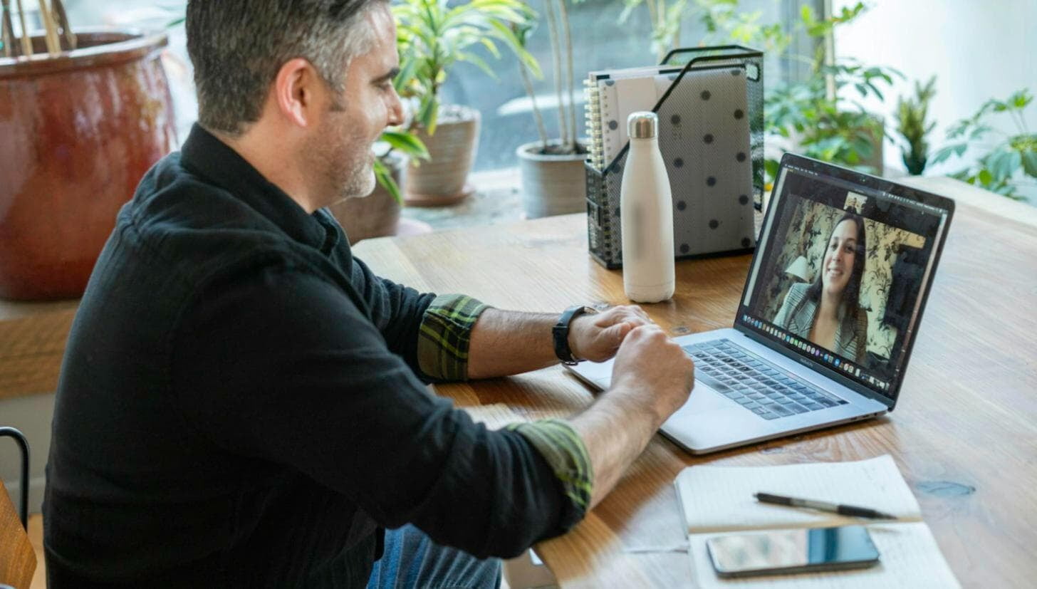 A one-to-one virtual coaching session on a laptop